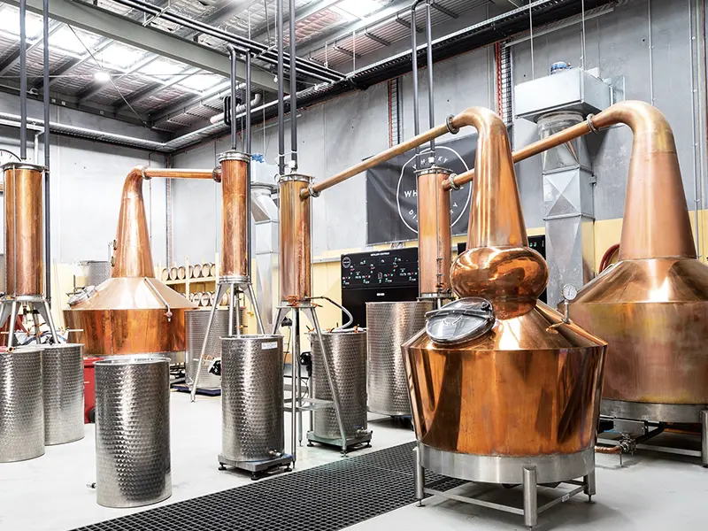 copper pot stills at the white label distillery for custom whisky production